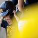Natalie Harper puts on a helmet in the dugout on Saturday, May 4. Daniel Brenner I AnnArbor.com